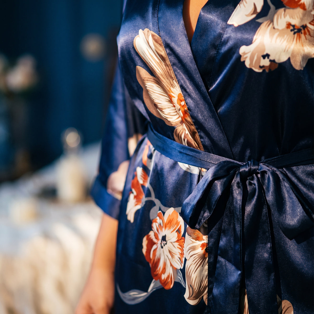 Détail de l'imprimé floral sur satin bleu marine et de la ceinture