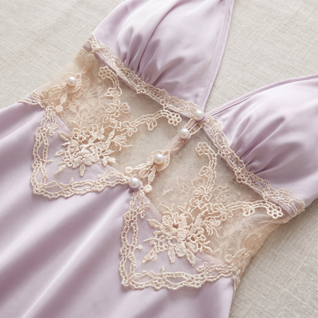 Détail de l'empiècement en dentelle crème et des perles à la taille