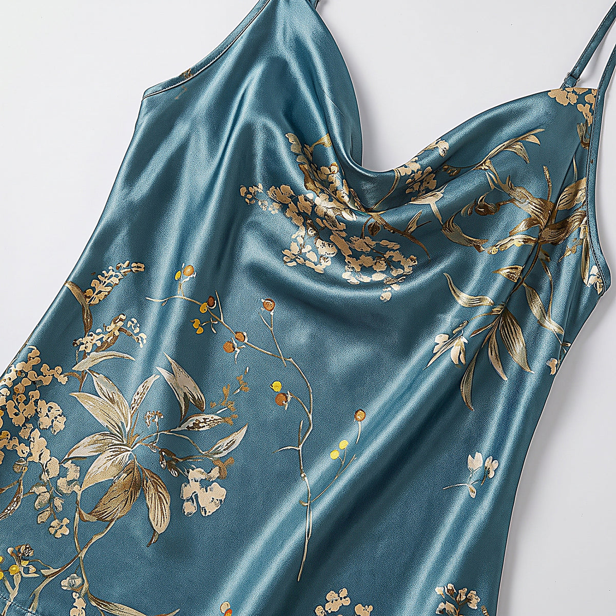 Détail de l'encolure drapée et de l'imprimé floral doré du caraco