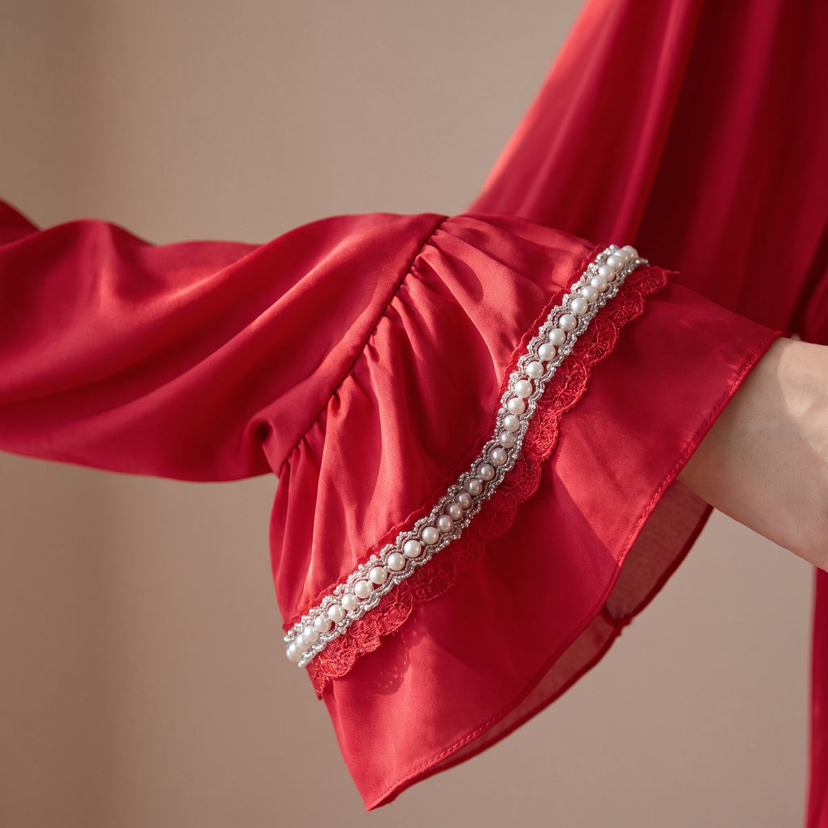Manche ample et poignet volanté du kimono en dentelle rouge