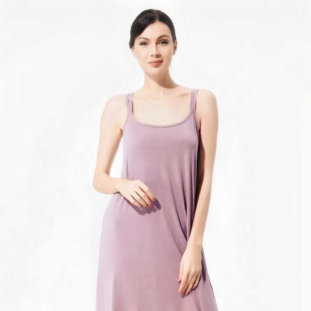 Femme souriante portant la nuisette violette, main sur la hanche, coupe fluide