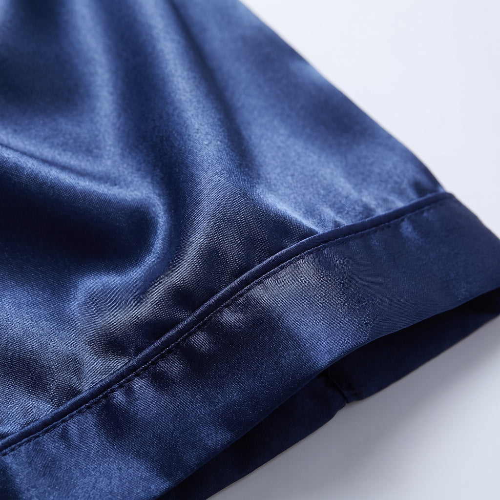 Détail du satin bleu marine du pantalon et de son liseré à l'ourlet