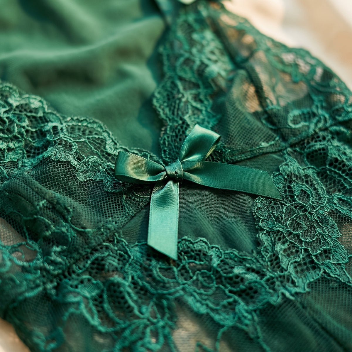 Détail du noeud satin vert sur la dentelle florale transparente