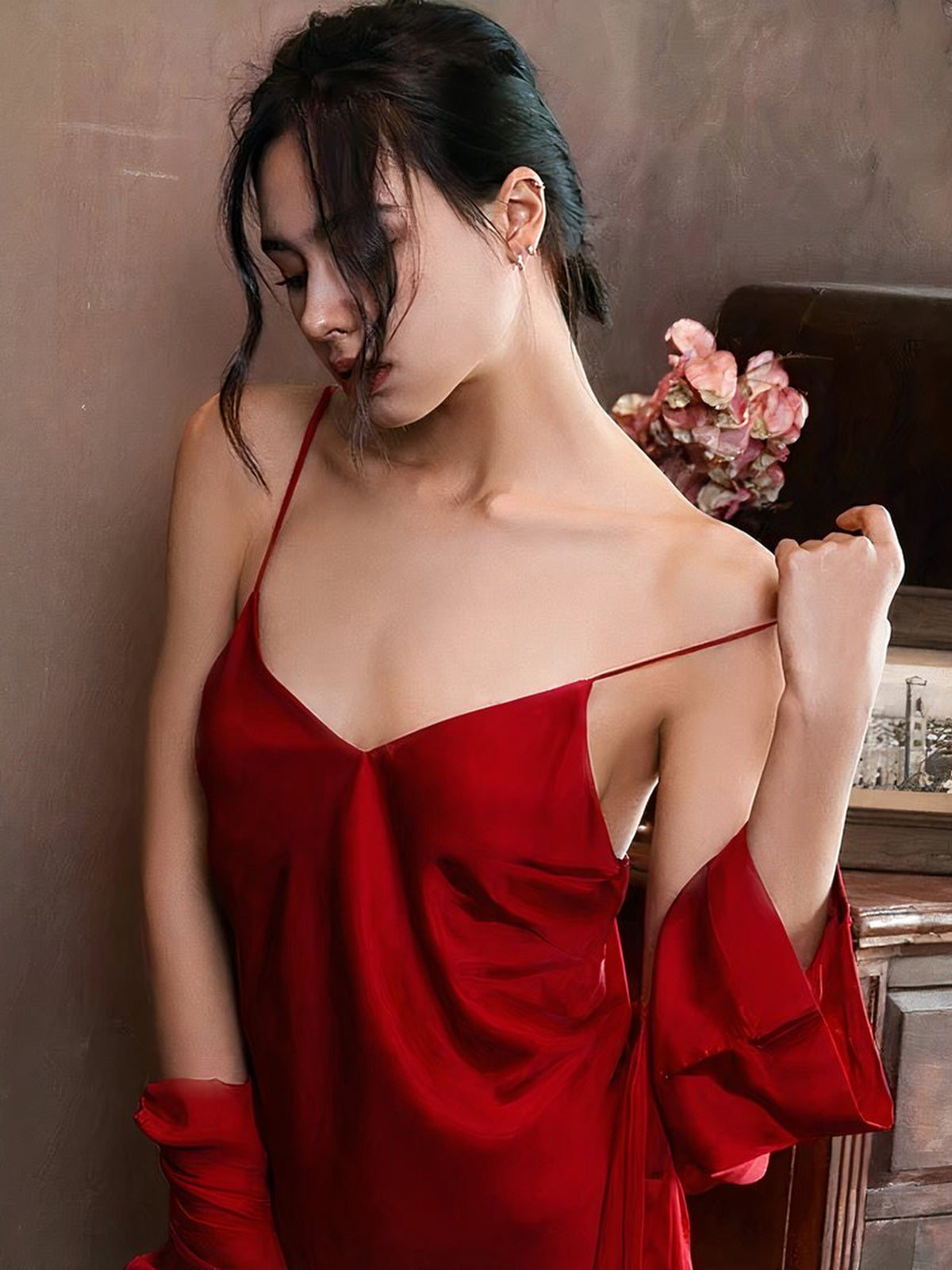 Portrait en boudoir portant la nuisette rouge avec le kimono glissé sur les bras