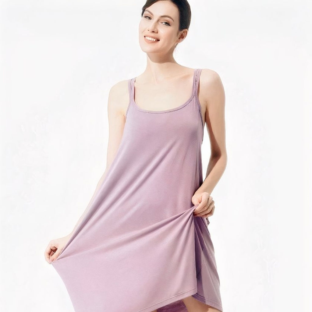 Femme ronde souriante portant la nuisette courte violette, tissu stretch tenu a deux mains, cadrage carre