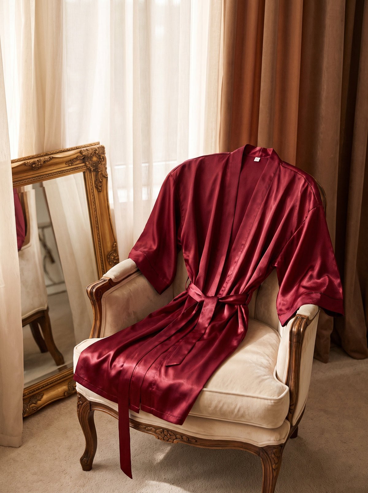 Peignoir satiné bordeaux drapé dans un décor boudoir élégant