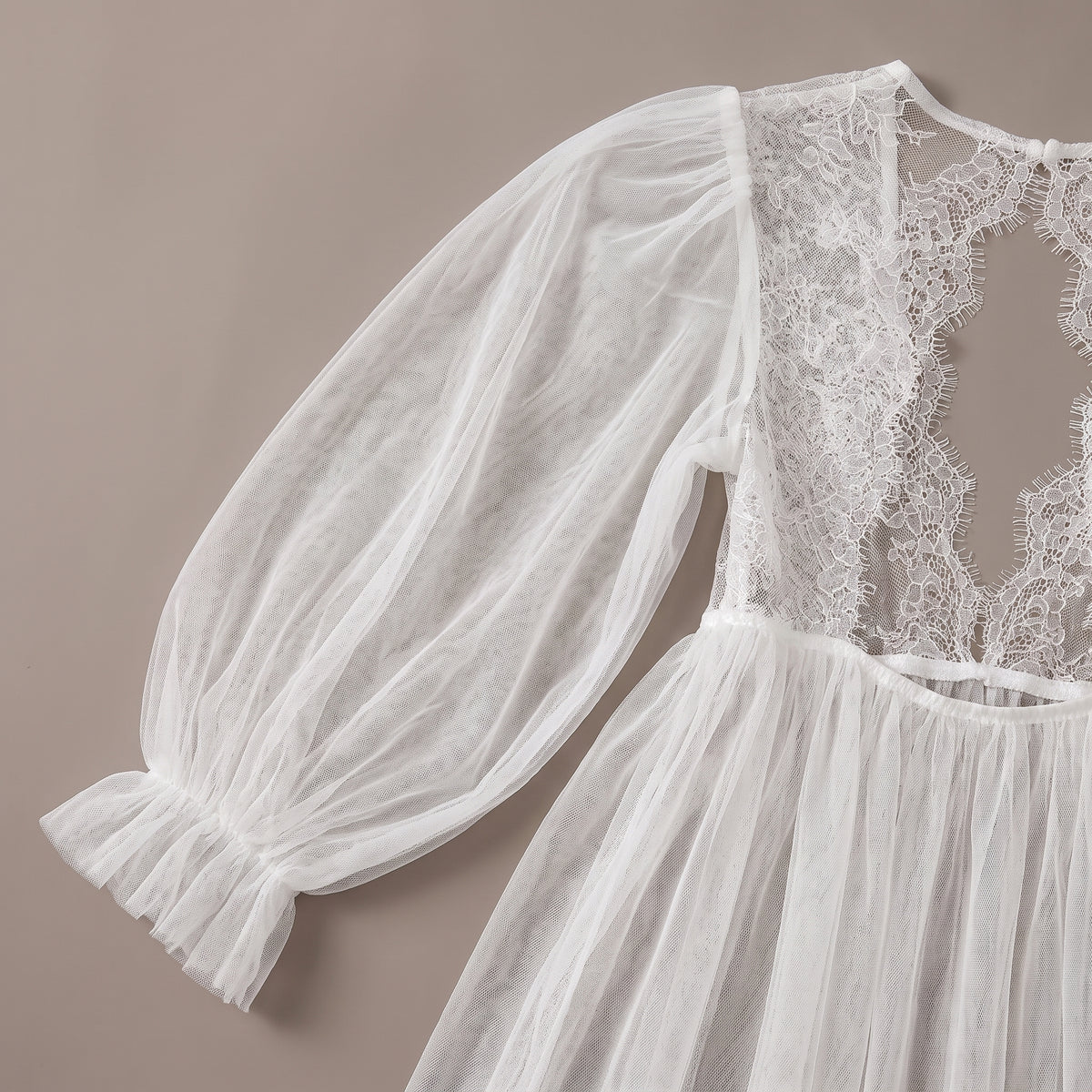Détail de la manche bouffante en tulle et du dos en dentelle ouvert