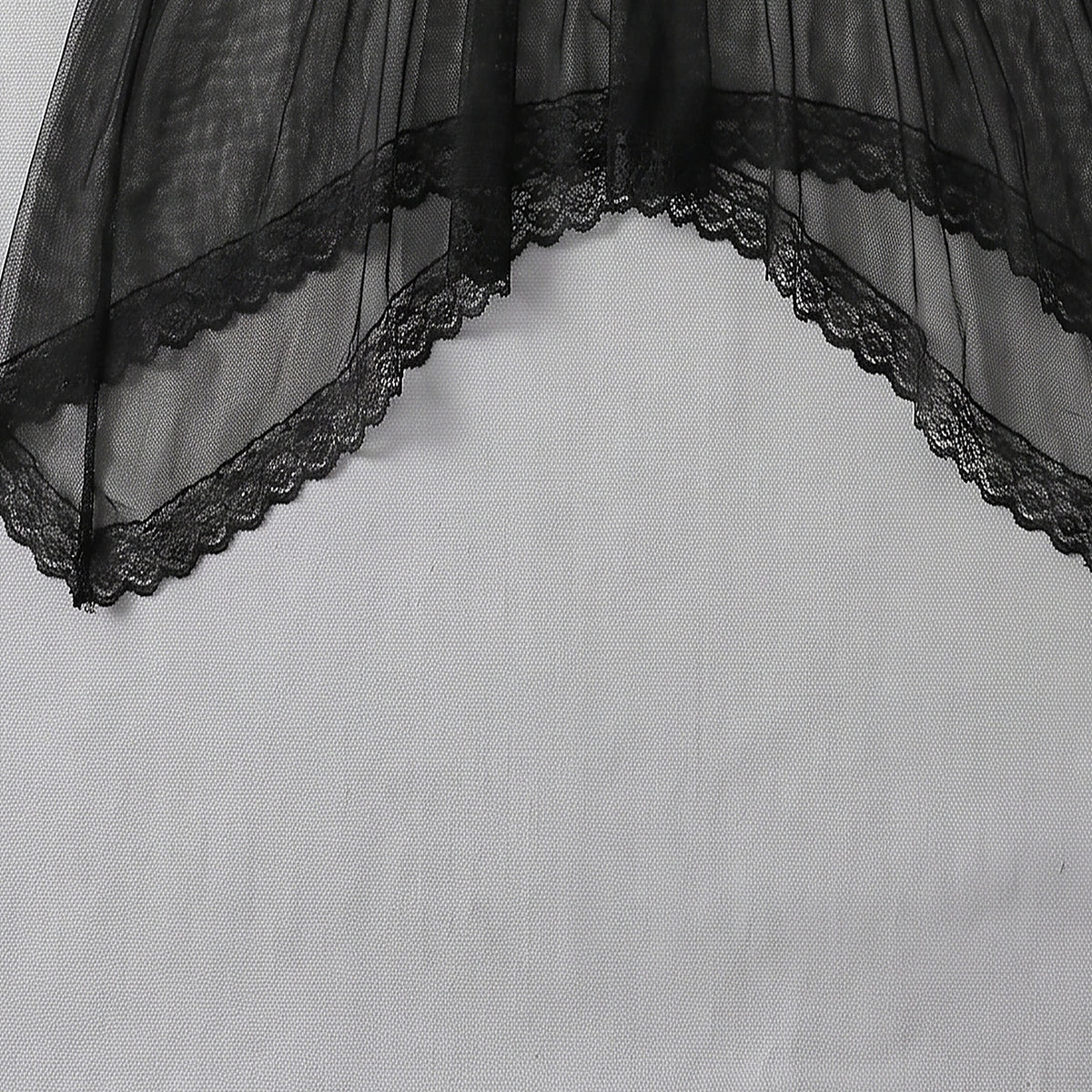 Détail du voile noir transparent et de l'ourlet festonné en dentelle
