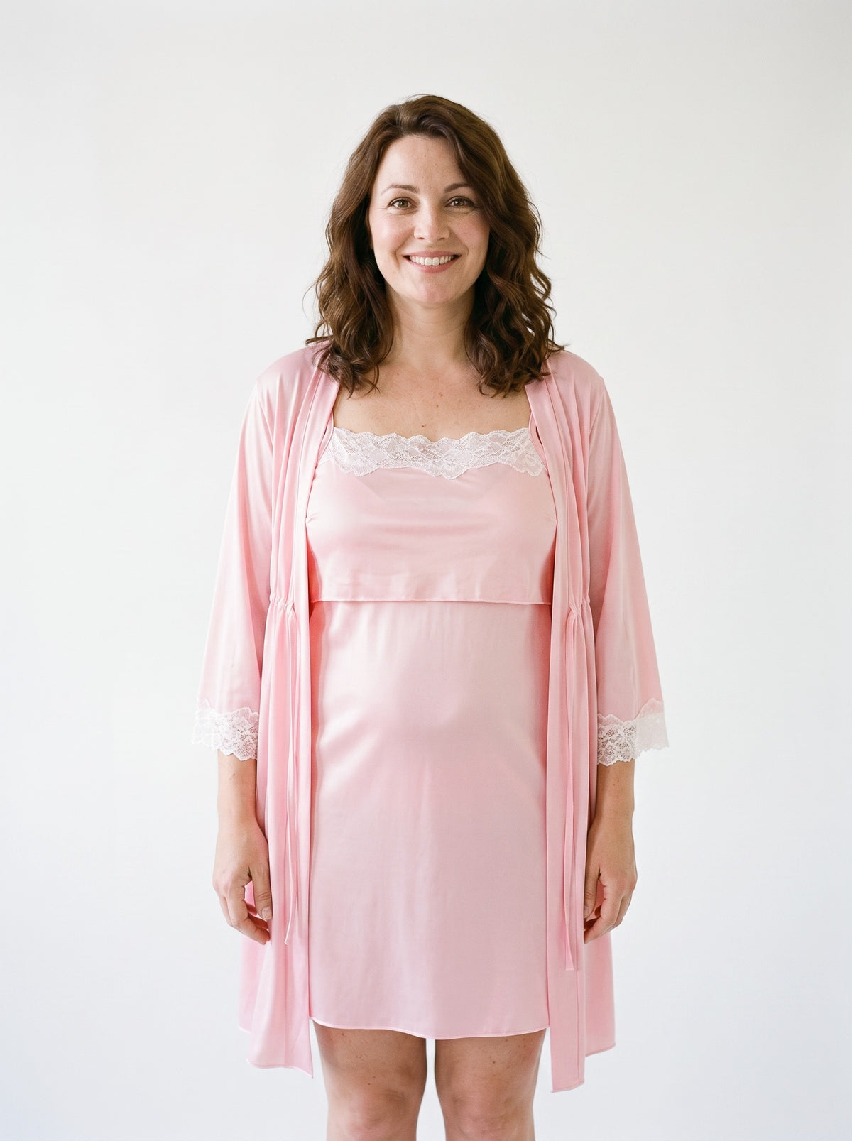 Ensemble nuisette de maternité rose porté par une modèle souriante, vue entière
