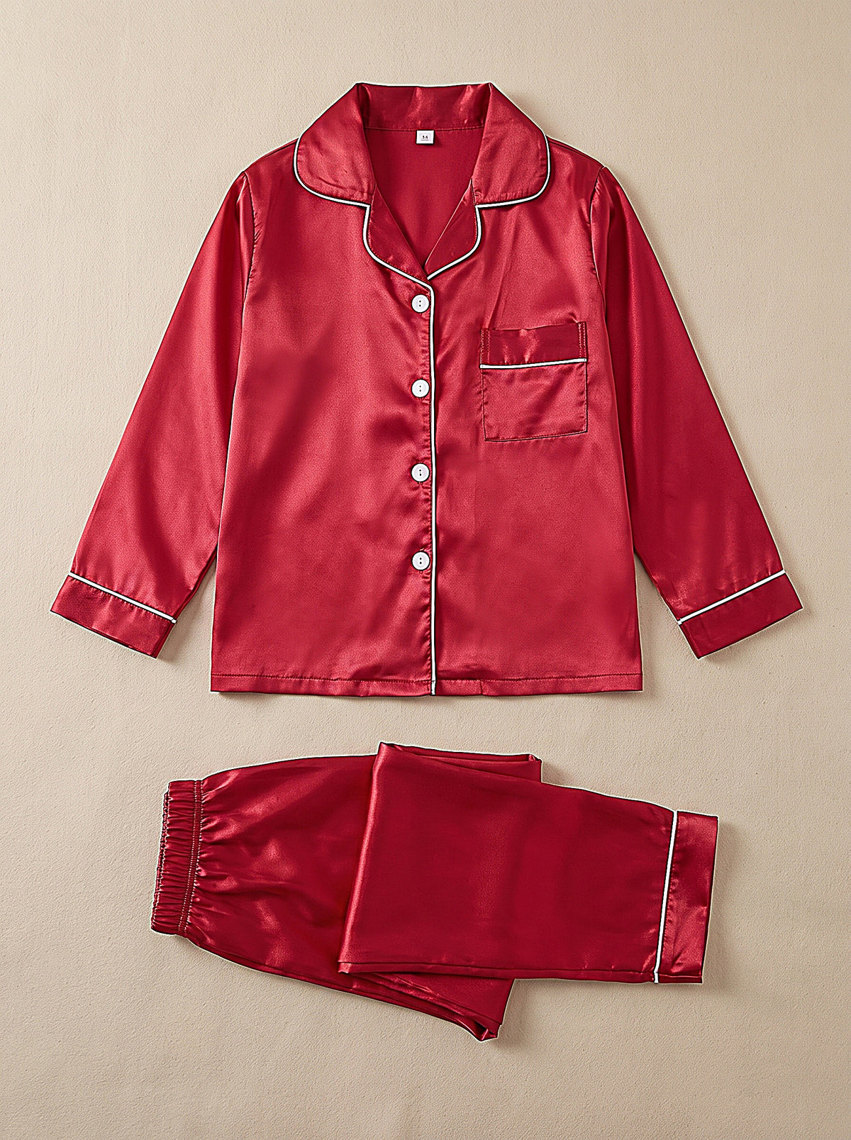 Pyjama fille en satin rouge à passepoil et boutons blancs, chemise et pantalon assortis