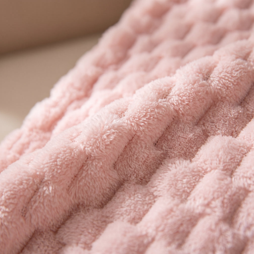 Macro sur la texture polaire gaufree du peignoir rose, detail des fibres en relief