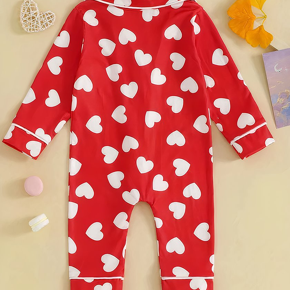 Dos du pyjama bébé rouge à cœurs blancs posé à plat