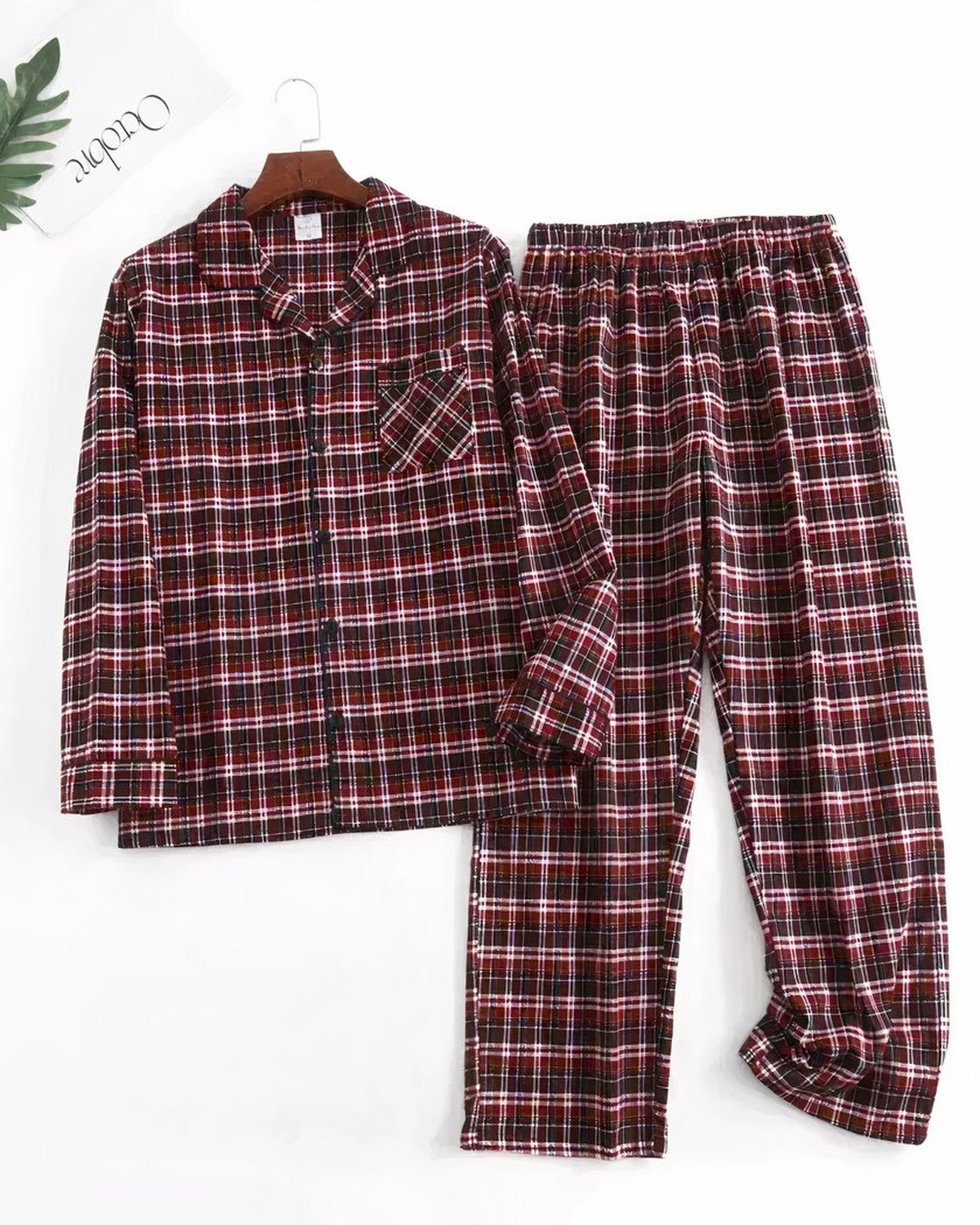Ensemble de pyjama homme rouge à carreaux posé à plat, chemise boutonnée et pantalon droit assorti