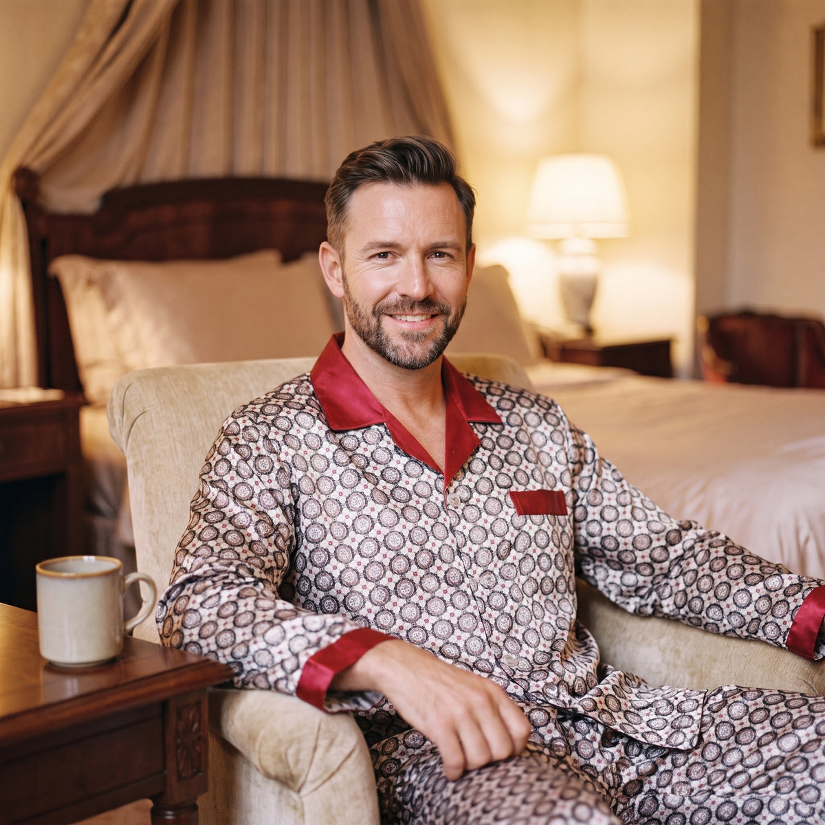 Homme assis en pyjama à motifs pendant une pause calme avec une tasse