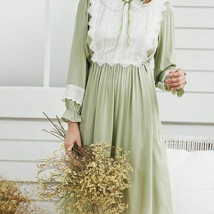 Femme portant une nuisette verte vintage en coton, détails blancs en dentelle, bouquet de fleurs séchées